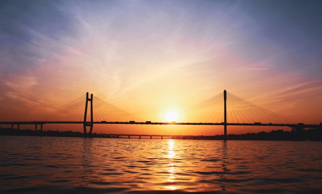 An image of the New Yamuna bridge with sunsetting in the background